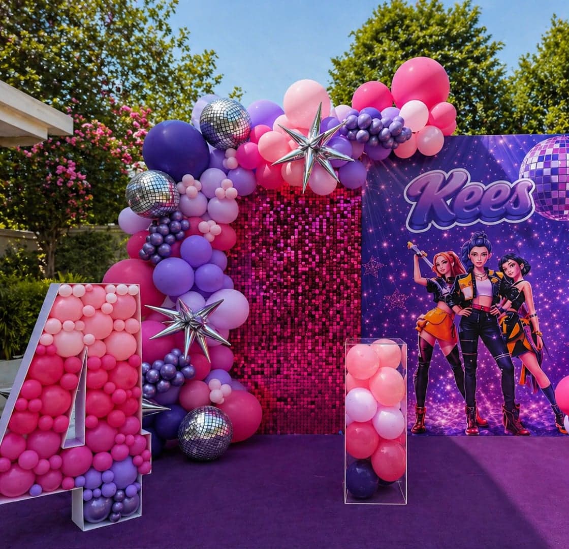 Pink and purple balloon arch with disco balls and Kees backdrop