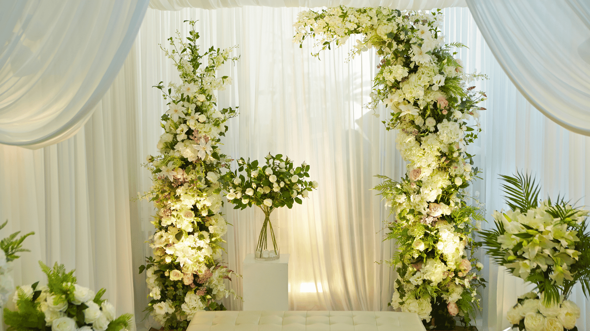 Gold luxury event decoration with floral arch and premium tableware